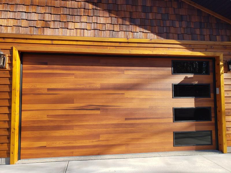 Wood panel garage door featuring side panel windows, combining natural wood aesthetics with functional design installed by A.S.A.P. Garage Door Repair